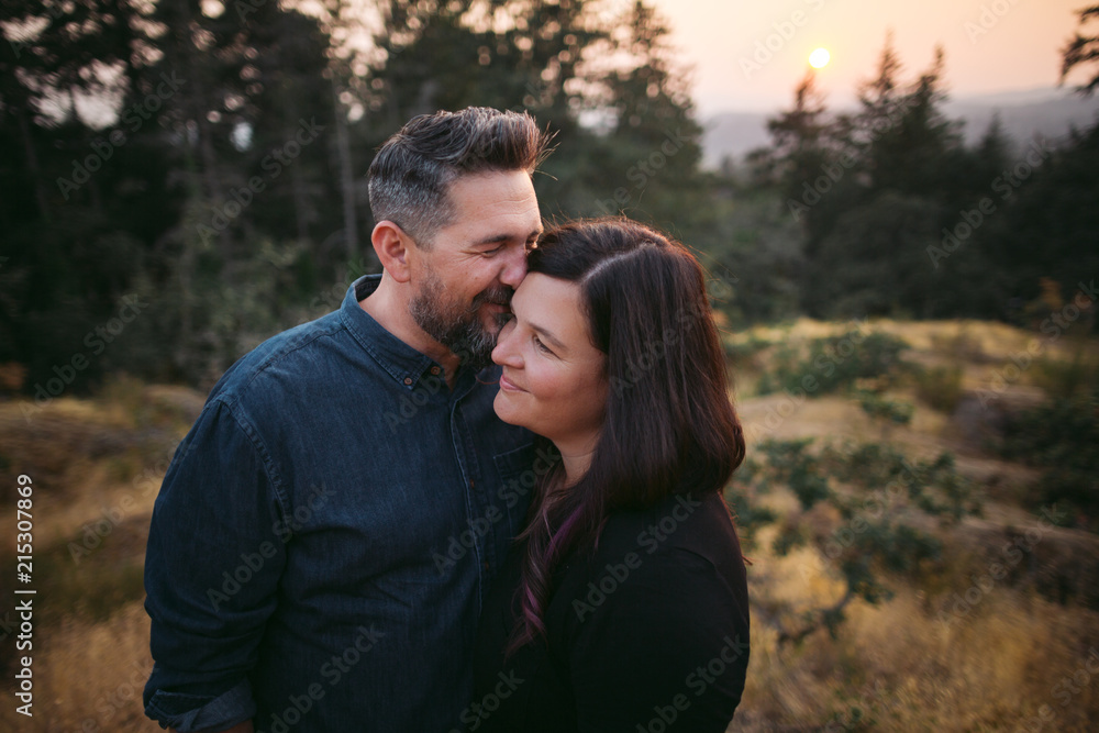 Loving couple together at sunset in nature Loving couple together at sunset in nature