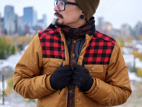 A man holds onto his trendy autumn jacket. photo