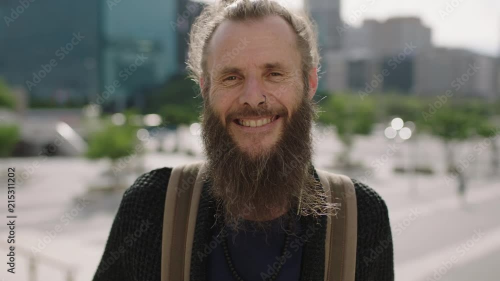 close up portrait of cheerful mature hippie man smiling happy in sunny urban city enjoying travel lifestyle close up portrait of cheerful mature hippie man smiling happy in sunny urban city enjoying travel lifestyle
