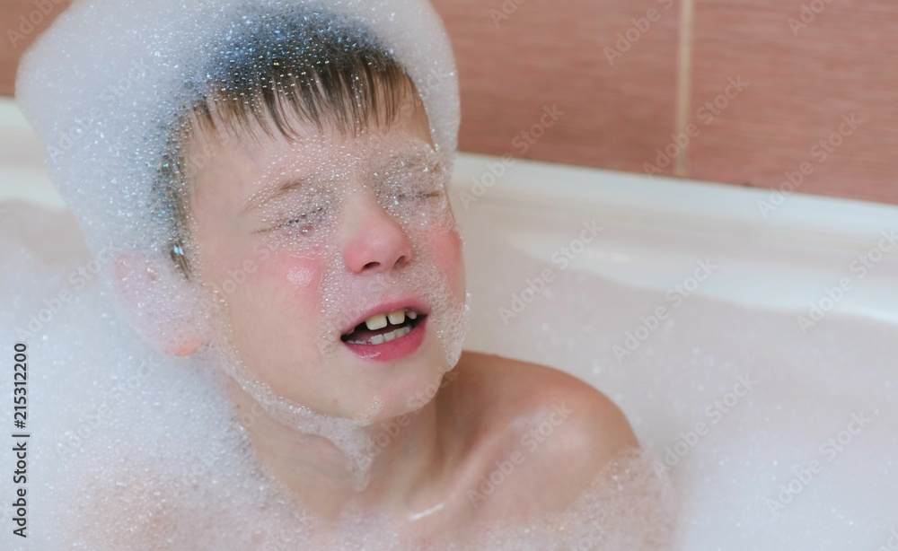 Boy 6-7 years prepare to dive into a bubble bath, eyes closed. Boy 6-7 years prepare to dive into a bubble bath, eyes closed.