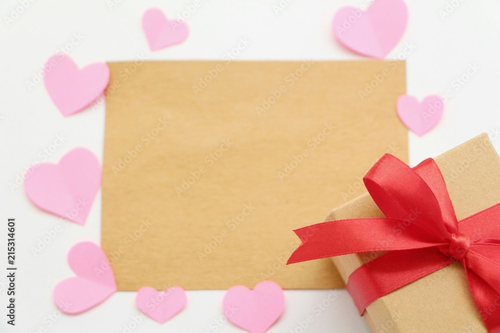 Brown blank card with paper heart shaped and gift box on white background,flat lay. Brown blank card with paper heart shaped and gift box on white background,flat lay.