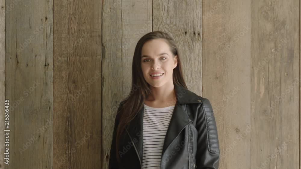 portrait of stylish young hispanic girl student smiling happy looking at camera wearing leather jacket confident independent female