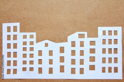 Paper cut of building in city landscape.