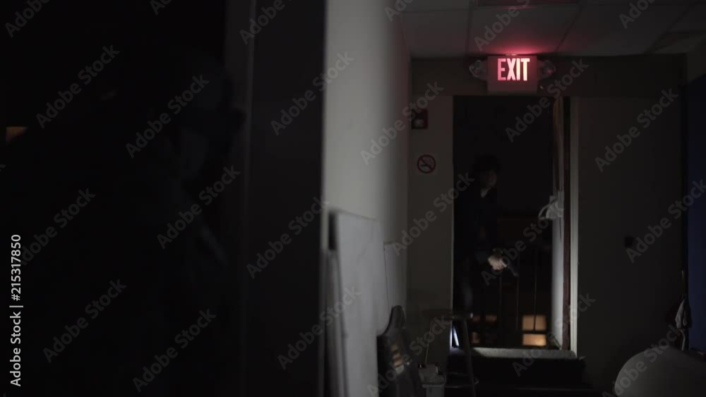 A shootout between two men in a hallway. A shootout between two men in a hallway.