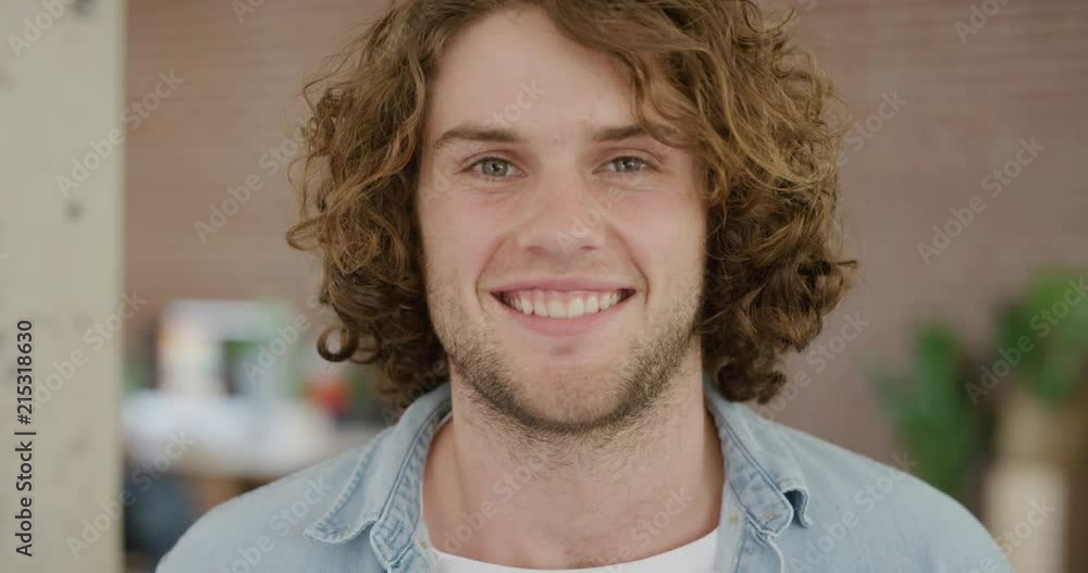 young caucasian man smiling portrait happy enjoying success satisfaction looking at camera cheerful friendly student in office workspace young caucasian man smiling portrait happy enjoying success satisfaction looking at camera cheerful friendly student in office workspace