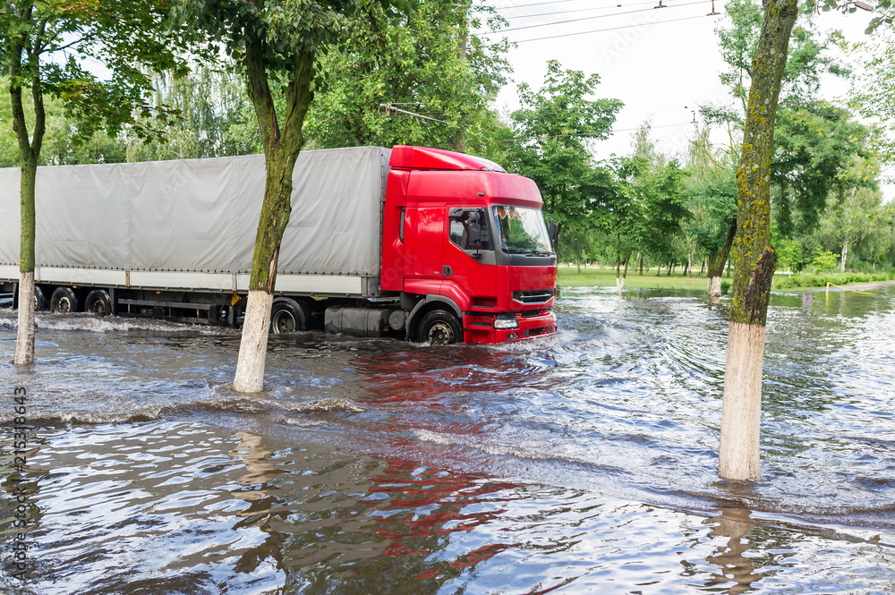 Big truck going through flooded street in town Gomel in Belarus