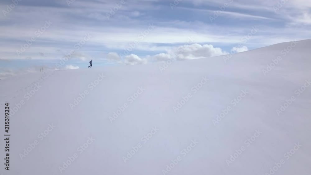 Winter mountain scenic view. Man walking in the snow. Wide shot, aerial. Winter mountain scenic view. Man walking in the snow. Wide shot, aerial.