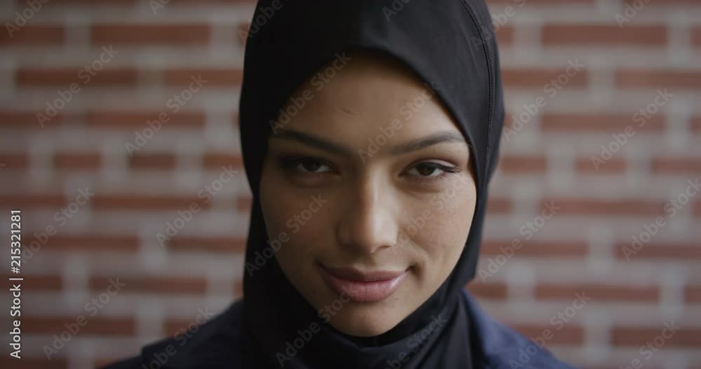 close up portrait happy young muslim woman smiling enjoying successful independent lifestyle mixed race female wearing hijab headscarf slow motion close up portrait happy young muslim woman smiling enjoying successful independent lifestyle mixed race female wearing hijab headscarf slow motion