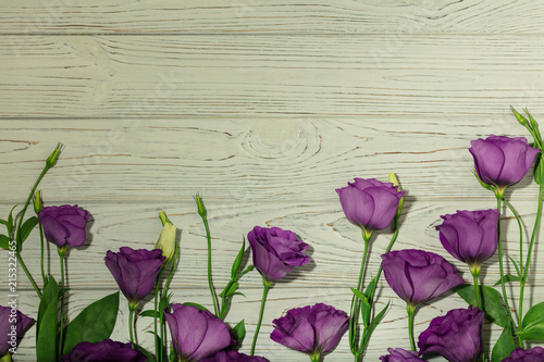 Violet flowers - eustoma  on a white wooden background.