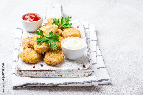 Fried crispy chicken nuggets with popular sauces photo