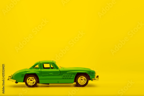 Little ancient model toy car isolated on background. © Nasibli