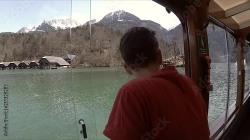 A boy drives a boat in Konigsee. photo