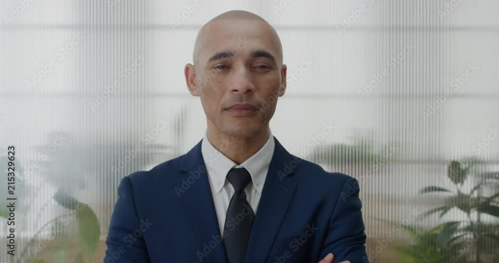 portrait young successful businessman arms crossed looking confident hispanic entrepreneur professional wearing suit slow motion portrait young successful businessman arms crossed looking confident hispanic entrepreneur professional wearing suit slow motion
