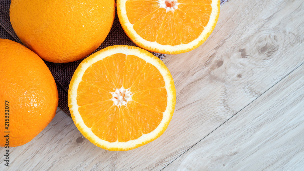Oranges fruit in a basket on a wooden table. Oranges fruit in a basket on a wooden table.