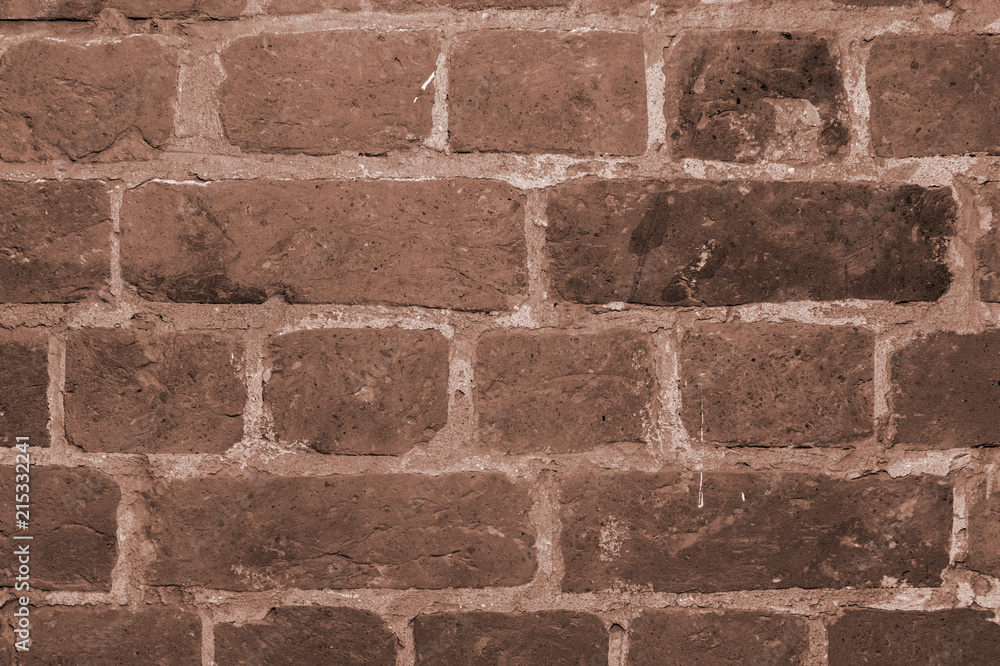 A toned background of a piece of brick wall closeup inside an antique antique house. Background, texture A toned background of a piece of brick wall closeup inside an antique antique house. Background, texture
