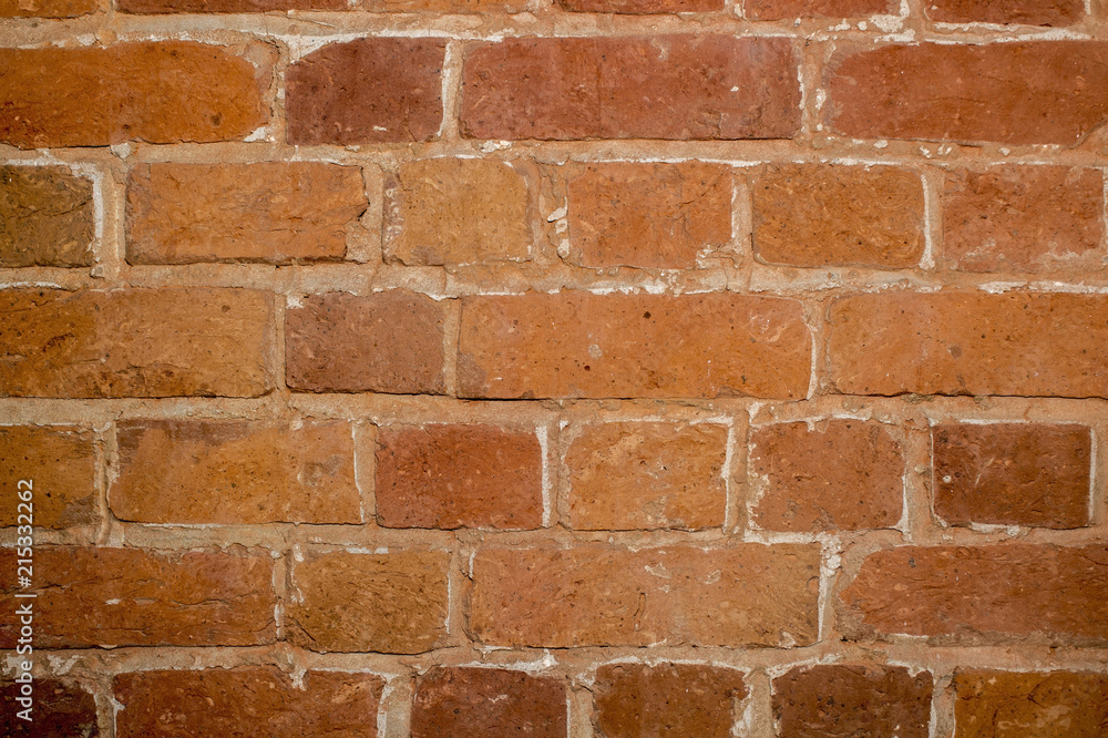 Naklejka premium Part of the wall of an old house inside of red brick close up. Background