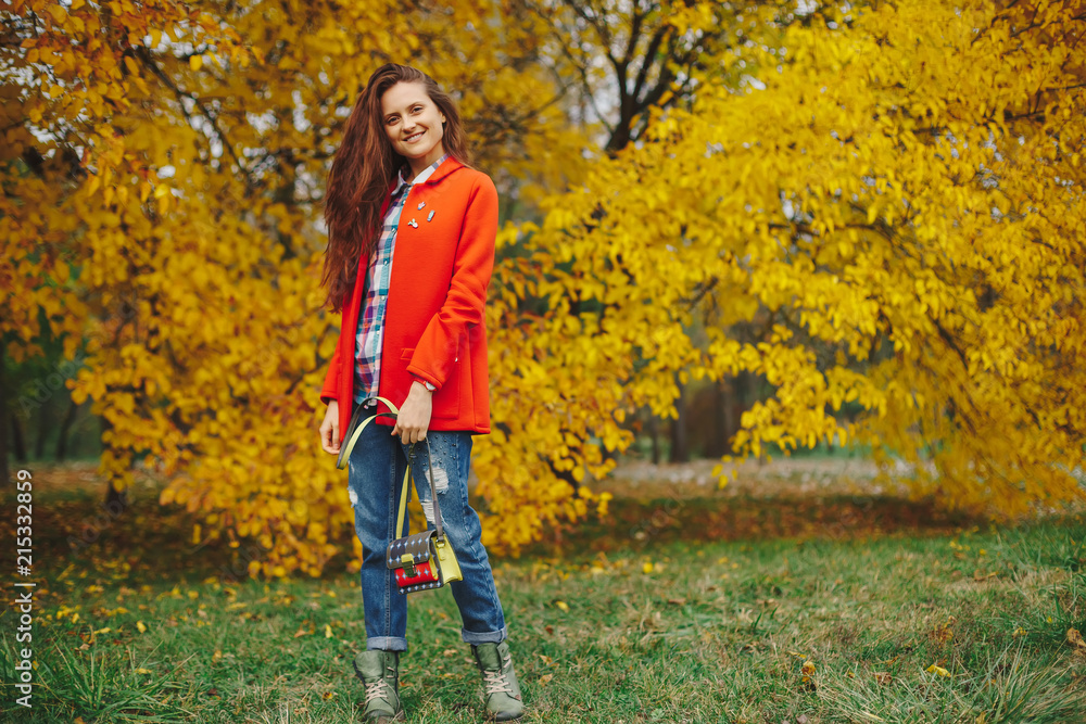 Girl with long wavy hair enjoying autumn in the park. Girl with long wavy hair enjoying autumn in the park.