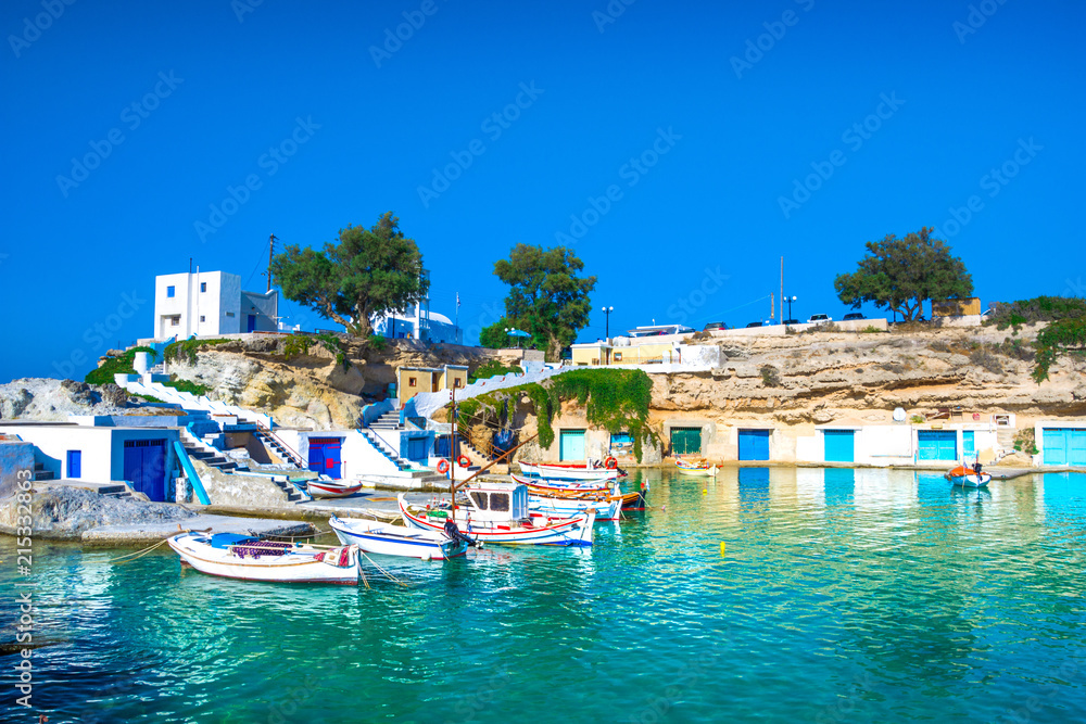 Scenic Mandrakia village (traditional Greek village by the sea, the Cycladic-style) with sirmata - traditional fishermen's houses, Milos island, Cyclades, Greece.