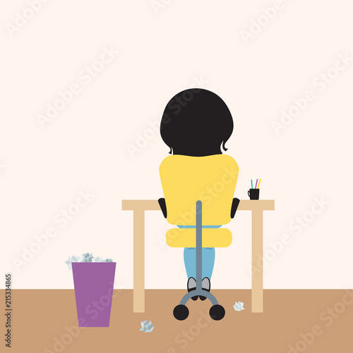 Young woman sitting on office chair at desk and paper basket, working from home or studying at school, or writing homework