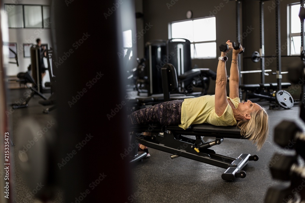 Woman exercising on machine in the gym Woman exercising on machine in the gym