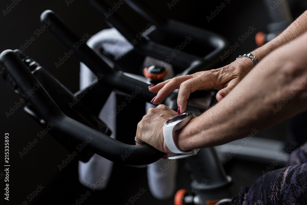 Close up of woman exercising on gym cycle Close up of woman exercising on gym cycle