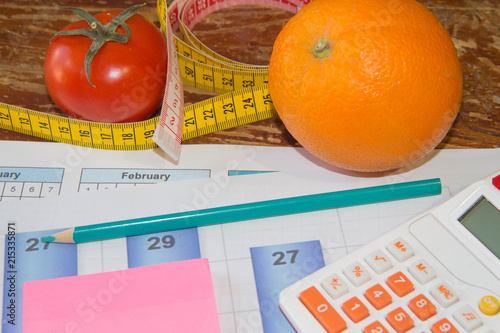 Concept of diet. Low-calorie fruit diet. Diet for weight loss. Plate with measuring tape and fruits on the table