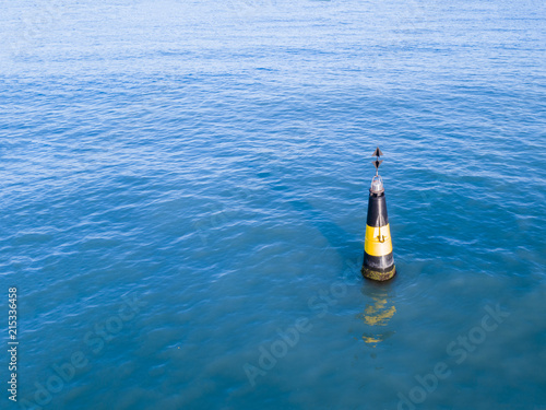 one safety buoy marker for marine ships in the sea water remote navigation abstract concept