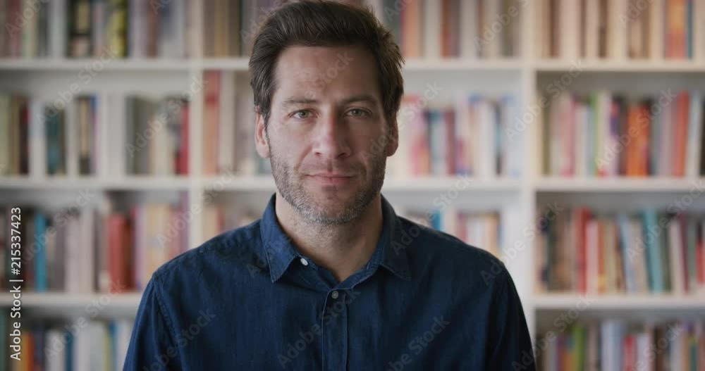portrait attractive young man turns head looking confident successful entrepreneur in library bookstore background slow motion portrait attractive young man turns head looking confident successful entrepreneur in library bookstore background slow motion