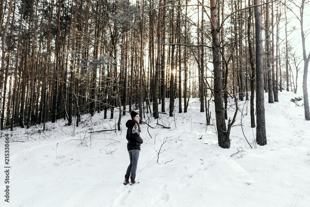 Hipster girl in winter forest.