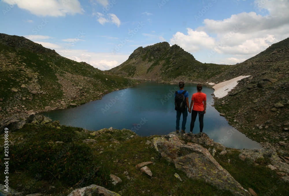 Tourists admire the mountain lake, Arkhyz.