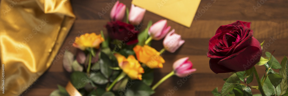 envelope and bouquet of flowers on wooden table envelope and bouquet of flowers on wooden table