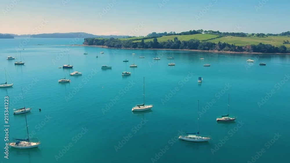Drone flying over turquoise waters with yachts on a sunny day Drone flying over turquoise waters with yachts on a sunny day