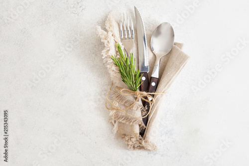  Food cooking background, set of wooden cutlery knife, spoon, fork with rosemary on whitebackground. Top view photo