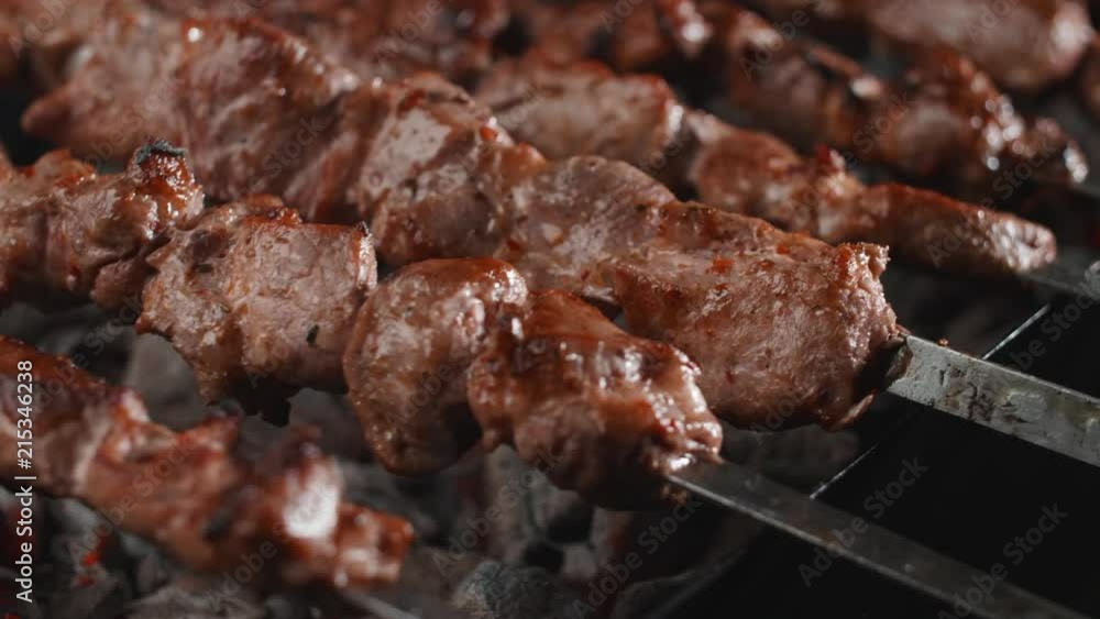 Higher angle on the smoking barbecue being flipped over the hot coals on the grill in backwards direction Higher angle on the smoking barbecue being flipped over the hot coals on the grill in backwards direction
