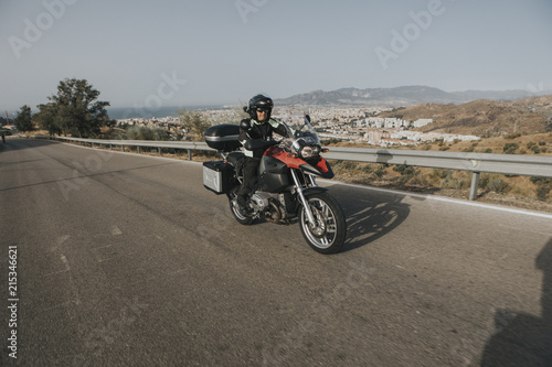 Man riding a touring motorbike during a trip across the mountains.