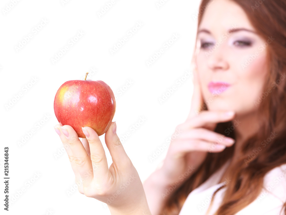 Woman holds red apple, focus on fruit Woman holds red apple, focus on fruit