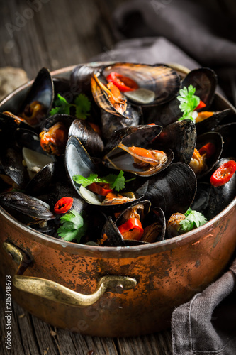 Closeup of mussels with coriander and chili peppers