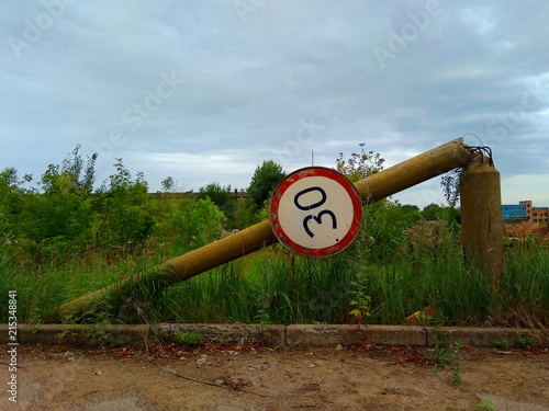 The fallen concrete column with a traffic sign 