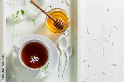 Hot tea with honey on white background © shaiith