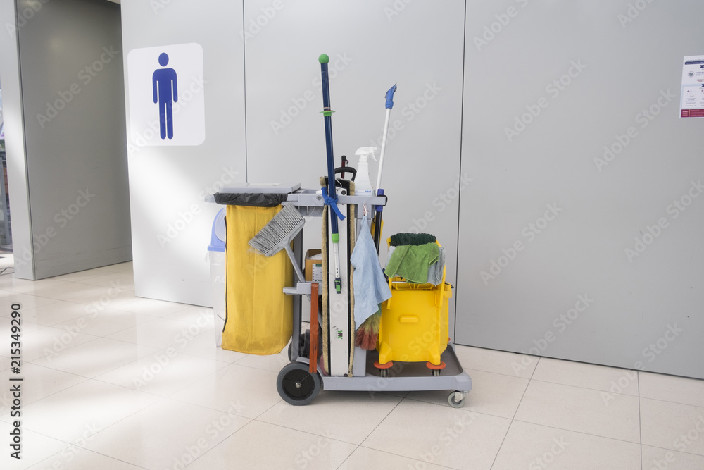 Cleaning cart at front of men toilet Cleaning cart at front of men toilet