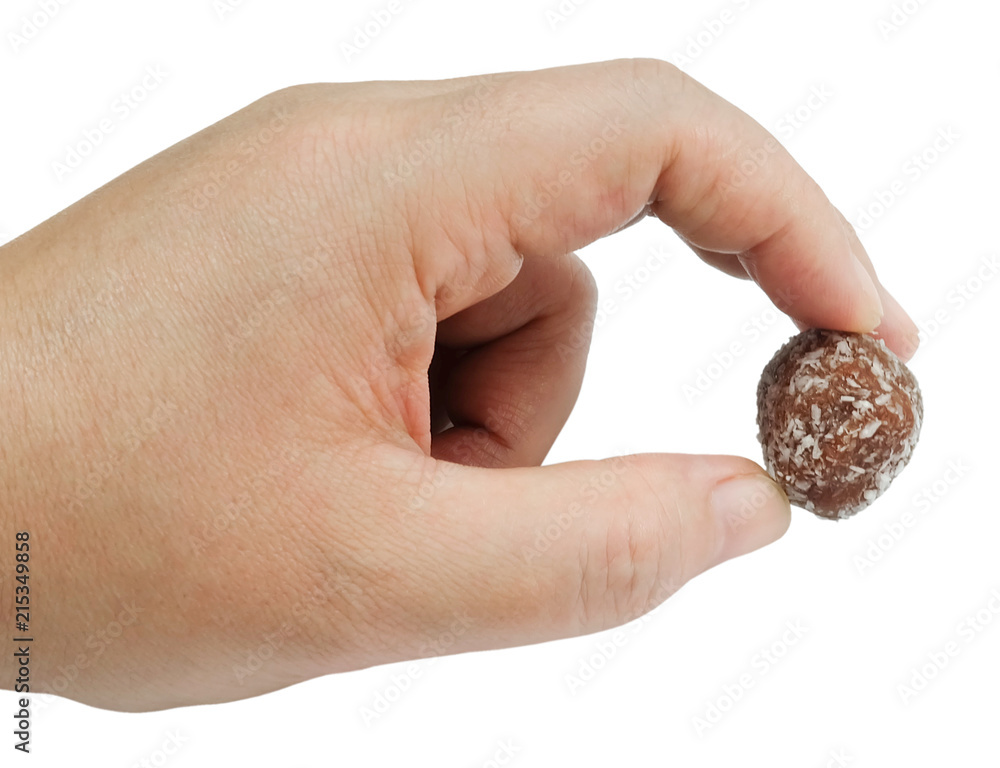 Hand Holding Chocolate Candy Balls with Grate Coconut Hand Holding Chocolate Candy Balls with Grate Coconut