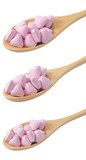Wooden Spoons Full with Vitamins on White