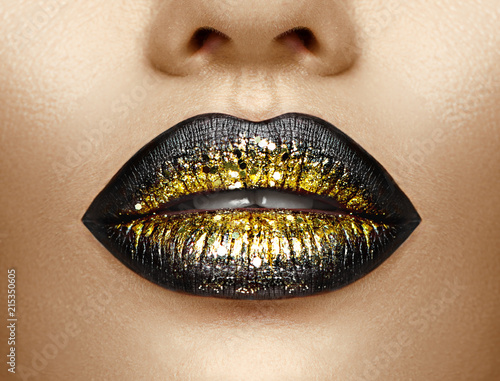 Lips makeup. Beauty high fashion gradient lips makeup sample, black with golden color. Sexy mouth closeup. Lipstick