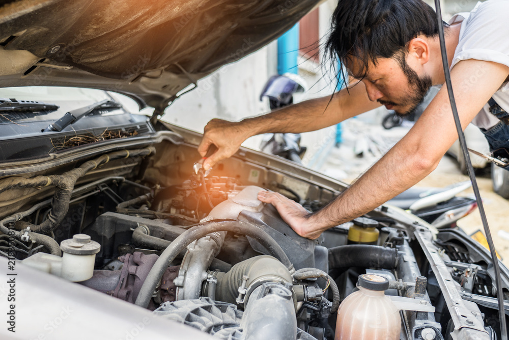 custom made wallpaper toronto digitalFixing car engine in automobile repair garage. Handsome mechanics in uniform are repairing car while working in auto service