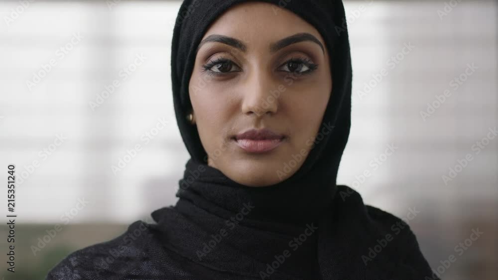 close up portrait of independent young muslim business woman looking serious confident at camera wearing traditional headscarf close up portrait of independent young muslim business woman looking serious confident at camera wearing traditional headscarf