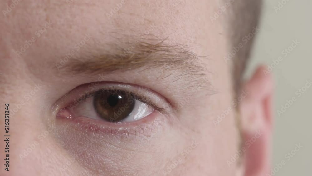 close up caucasian man eye opening blinking looking at camera pensive contemplative close up caucasian man eye opening blinking looking at camera pensive contemplative