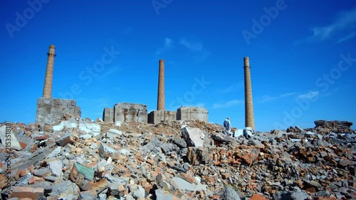 a man walks through the ruins of an old factory