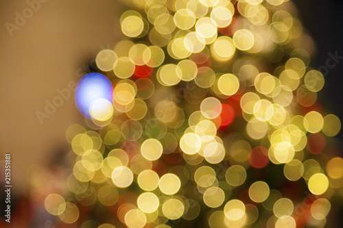 Blurry red Christmas balls on artificial Christmas tree.Christmas Holiday Blurred Background.