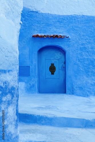 Blue door in the medina of Chefchaouen, Morocco © spumador