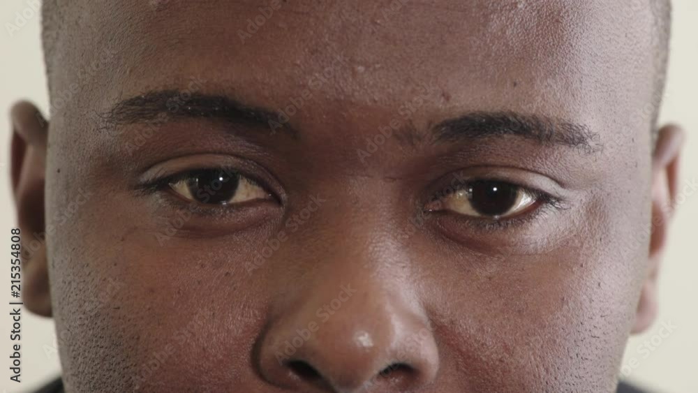 close up young african american man eyes looking pensive contemplative staring at camera eyesight health close up young african american man eyes looking pensive contemplative staring at camera eyesight health